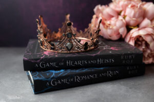 image of both books in the series with a crown on top and flowers